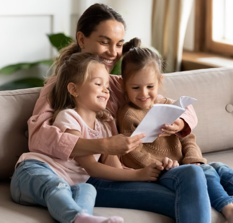 Mother and two children reading a book