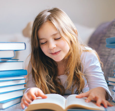 School child reading a book